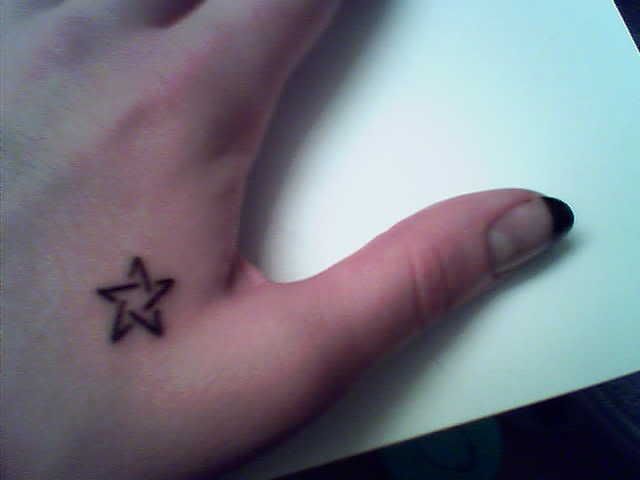 star tattoo on side of hand