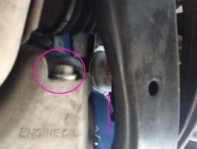 2006 Honda Accord V6 EX engine oil drain location, This is the view looking up at the passenger side wheel.  The oil drain bolt is circled in pink.  A pink arrow is pointing to the oil filter.